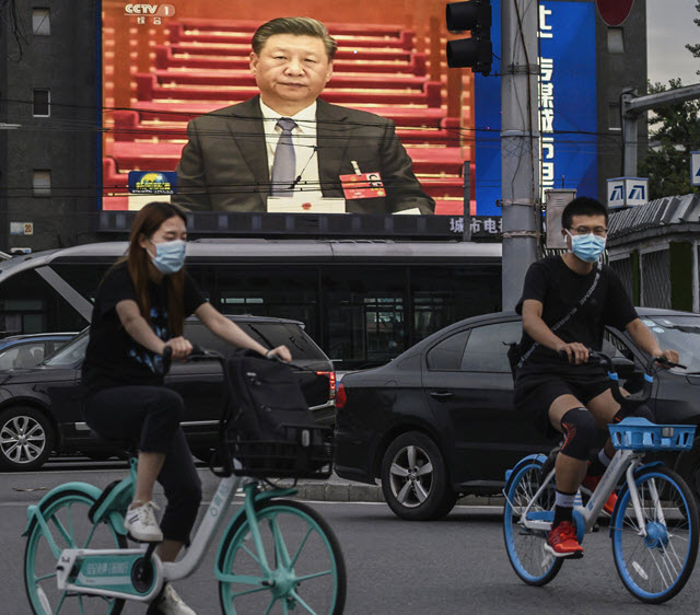 Chinese president Xi Jinping is seen on a large screen